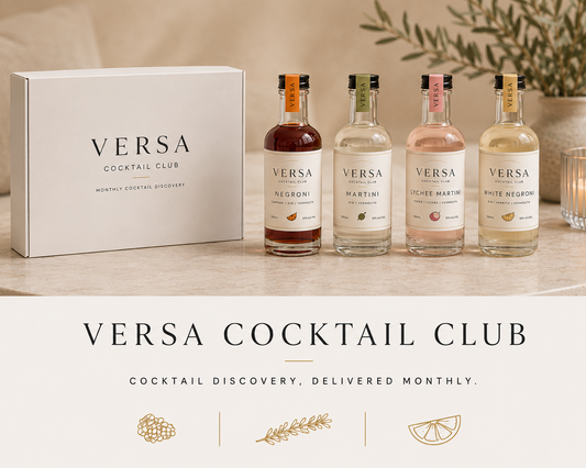 Versa Cocktail Club bottles and packaging on a table with decorative elements.